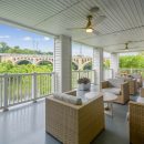 Deck with outdoor furniture and view of river and bridge