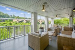 Deck with outdoor furniture and view of river and bridge